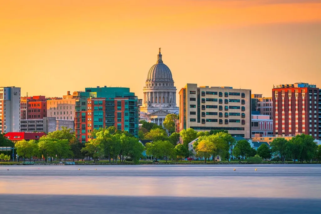 Madison, Wisconsin, USA downtown skyline at dusk on Lake Monona.