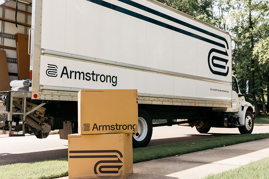 Armstrong white truck unloading boxes