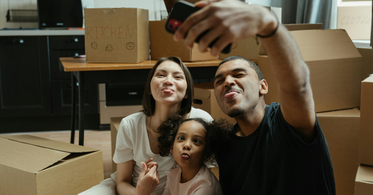 mom, dad and daughter making silly faces after moving into a new home in Fort Mill South Carolina
