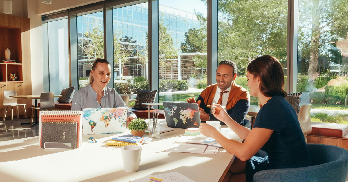 Coworkers in a meeting with a window overlooking Fort Mill