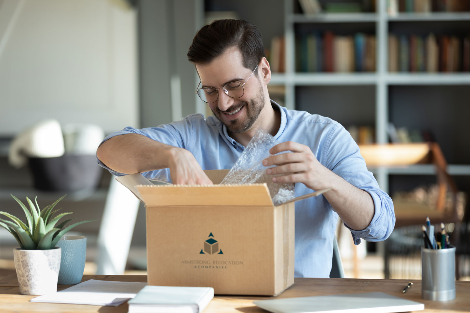 man in glasses packing