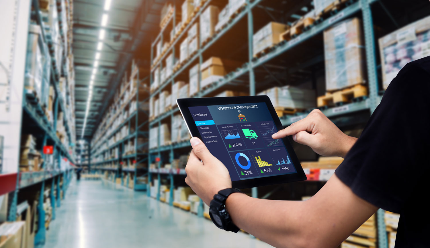 man holding ipad in warehouse