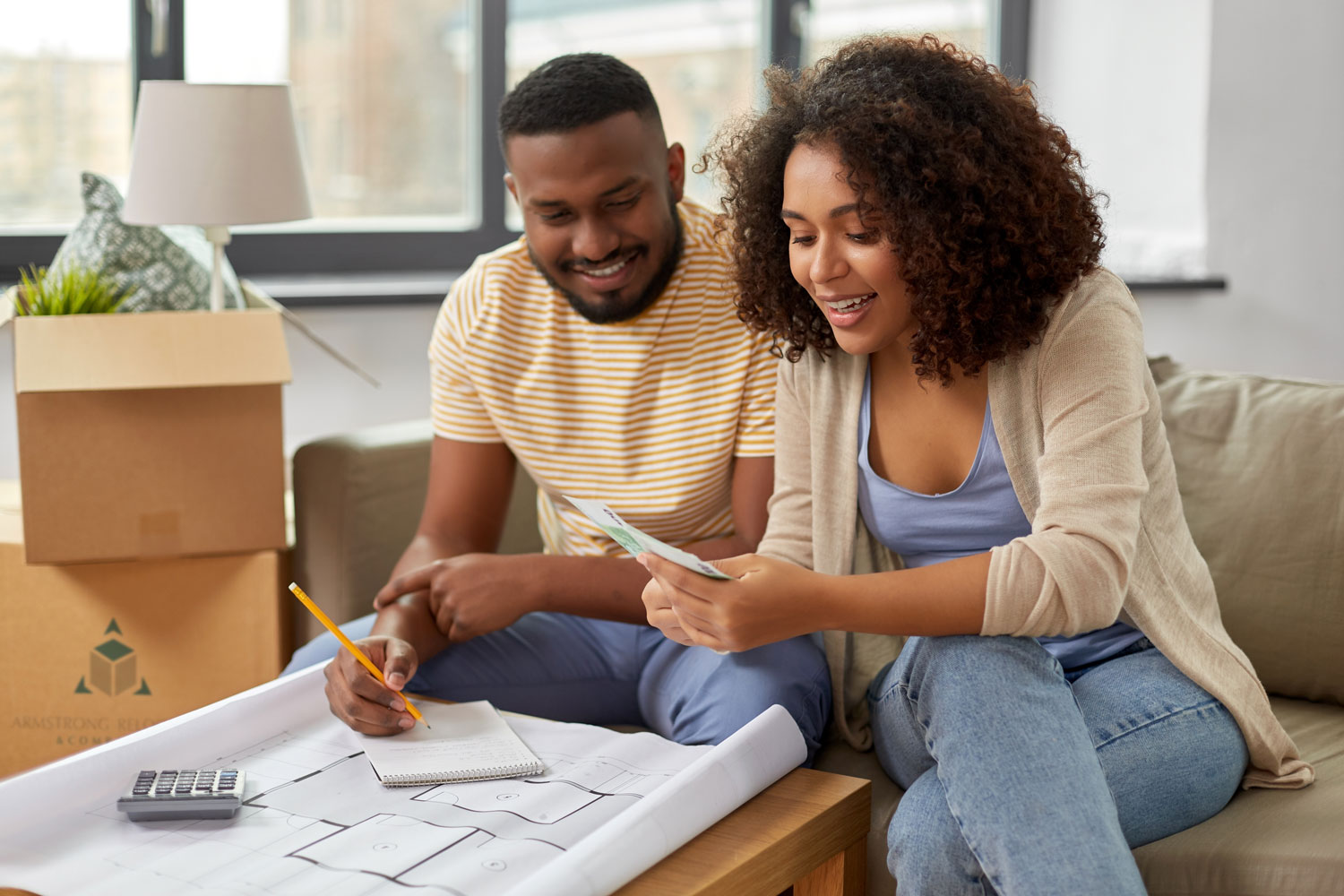black couple reviewing budget and floor plans